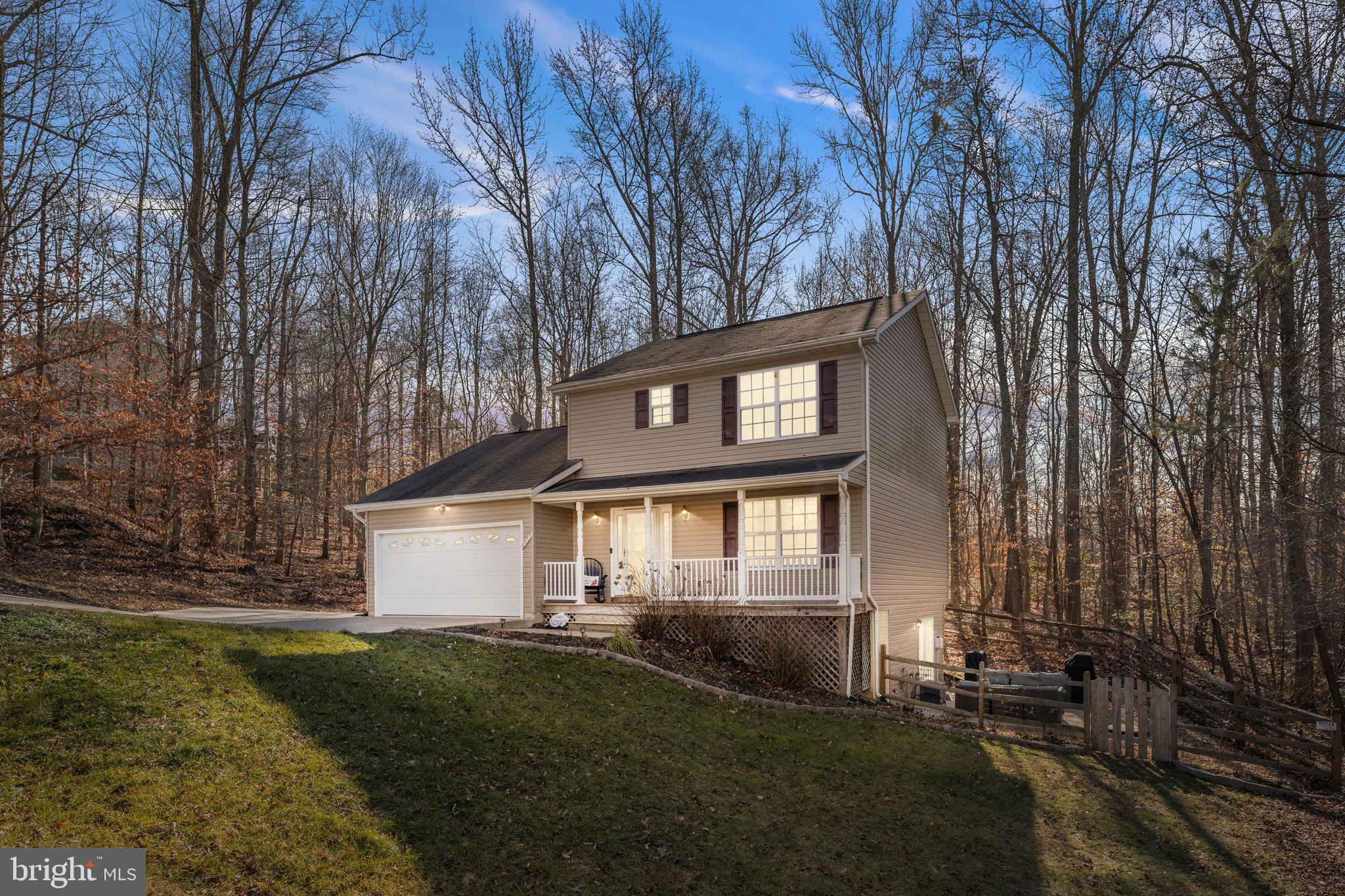 6463 Wheeler Drive King George, VA 22485 - Photo 5 of 57 a front view of a house with a yard and lake view