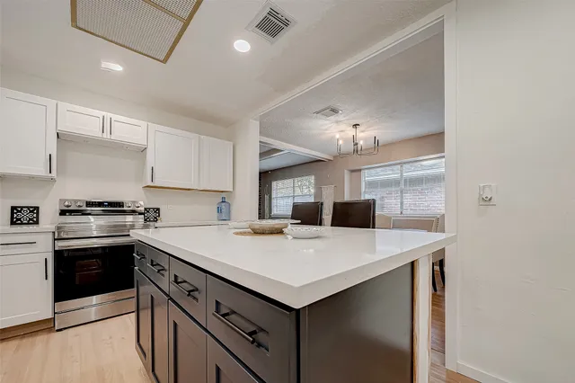 a kitchen with a stove a sink and a refrigerator