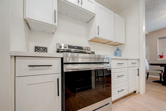 a kitchen with stainless steel appliances granite countertop a stove and a microwave