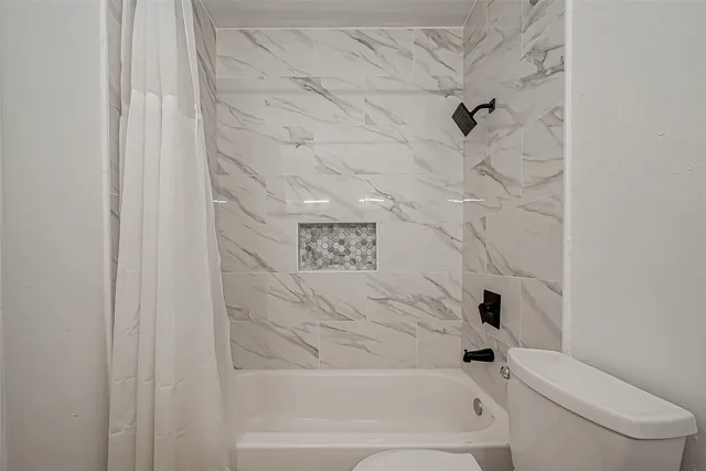 a bathroom with a bathtub and a toilet