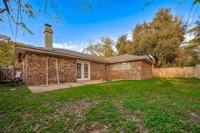 a view of a house with a yard and sitting area