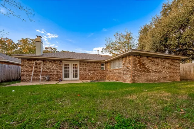 a view of a house with a yard and deck