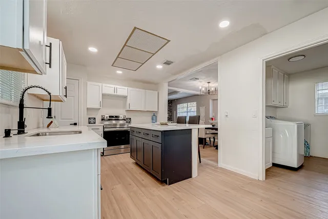 a kitchen with stainless steel appliances granite countertop a stove cabinets and sink