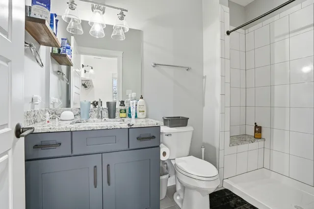a bathroom with a sink toilet and shower
