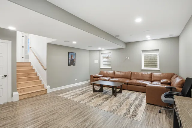 a living room with furniture and a wooden floor