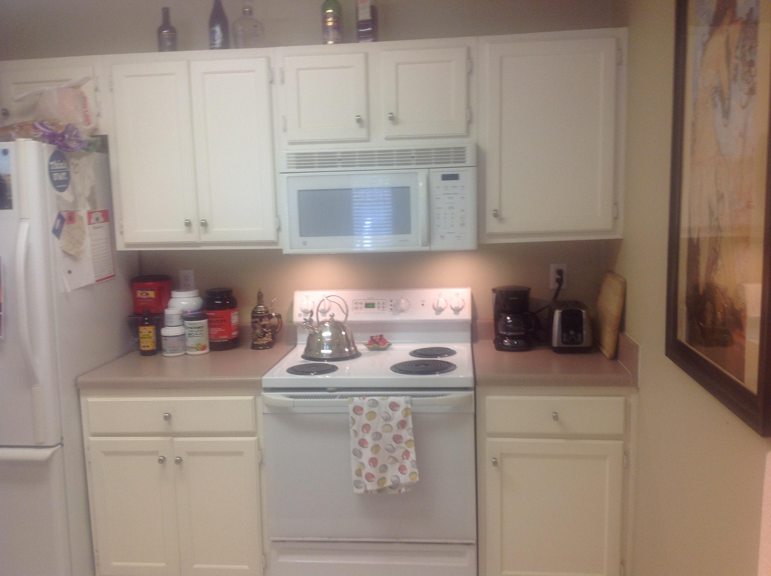 504 Keystone Road Mary Esther, FL 32569 - Photo 5 of 17 a kitchen with white cabinets and white appliances