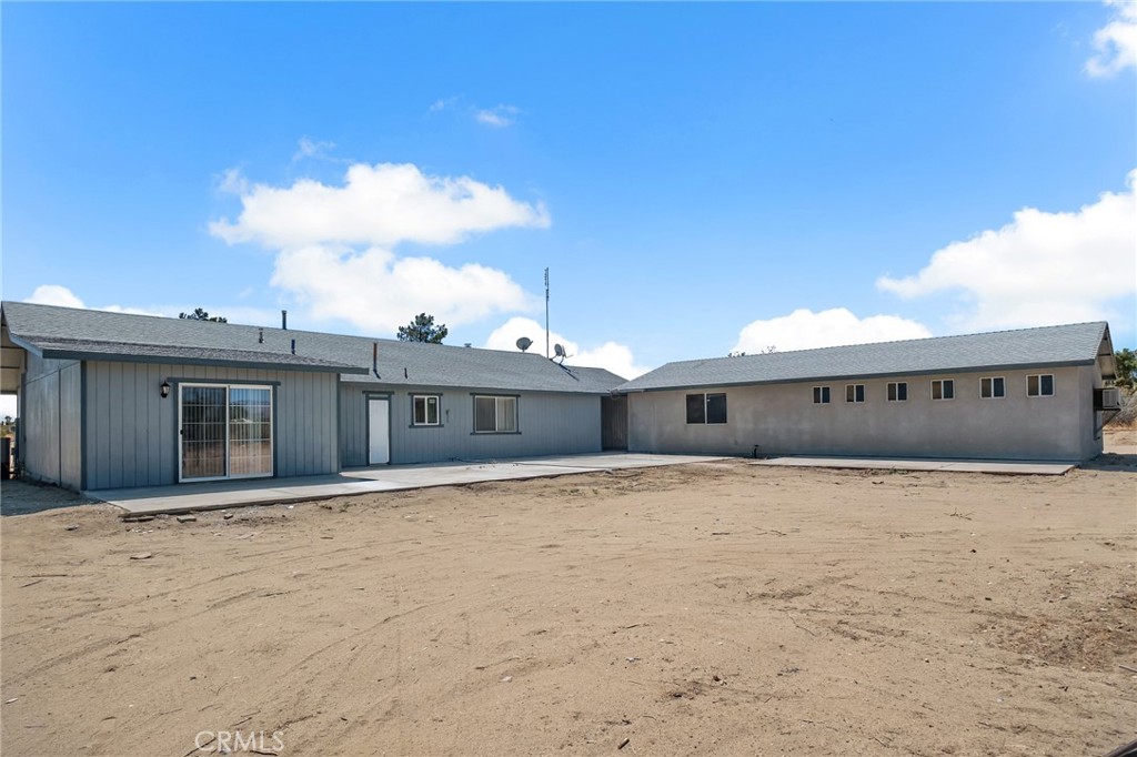 12736 Oasis Road Pinon Hills, CA 92372 - Photo 28 of 33 a house with trees in front of it