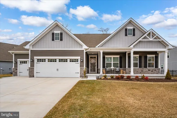 a living room with furniture wooden floor and a large window