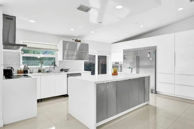 a kitchen with sink and refrigerator