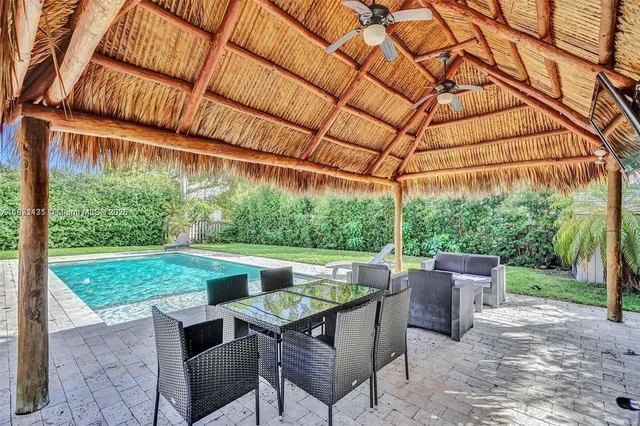 a backyard of a house with yard and outdoor seating