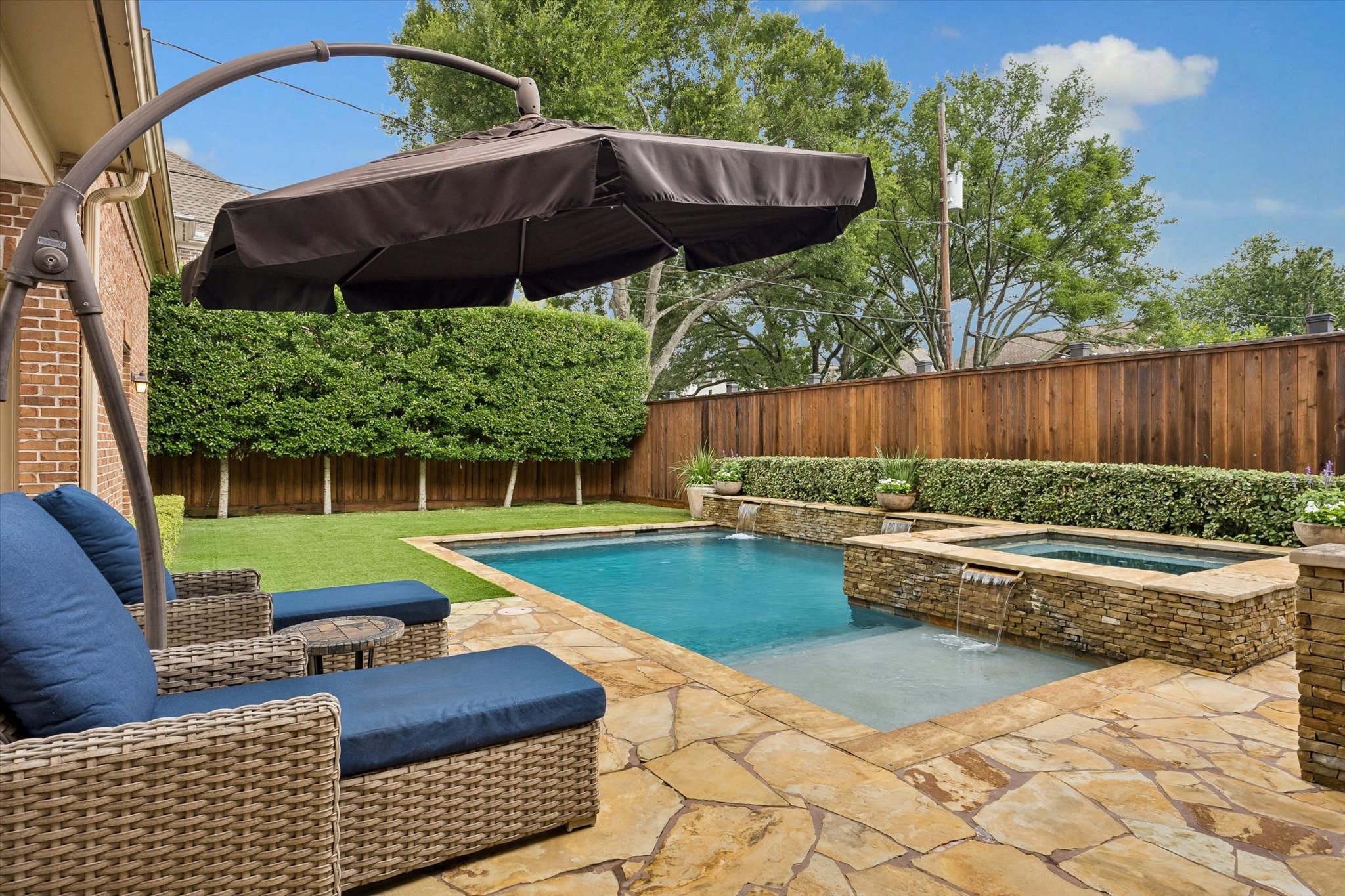 6358 Auden Street Houston, TX 77005 - Photo 43 of 50 a view of a backyard with couches plants and large pool
