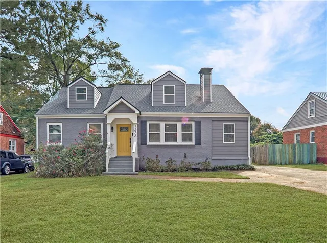 a front view of a house with a garden