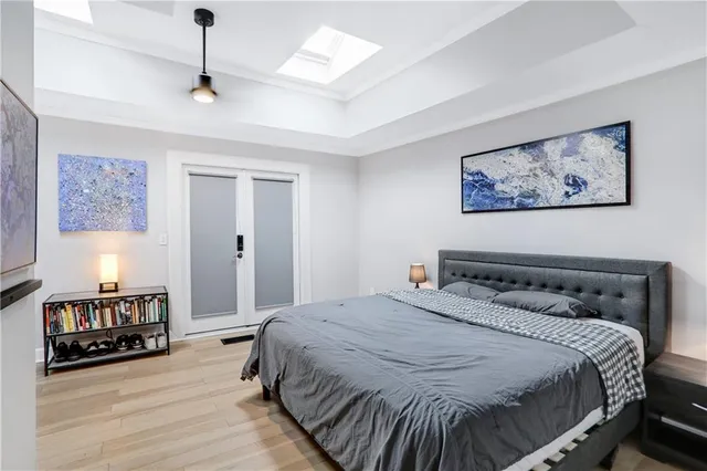 a bedroom with a bed and wooden floor