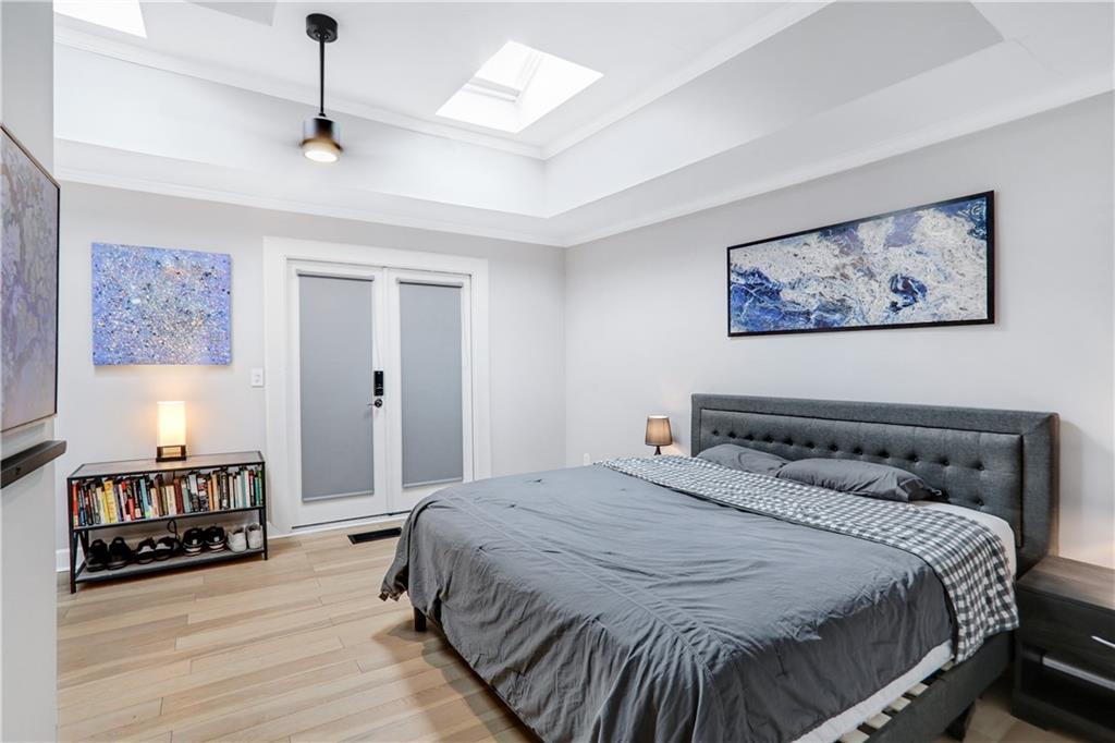 1275 Eastland Road Southeast Atlanta, GA 30316 - Photo 12 of 31 a bedroom with a bed and wooden floor