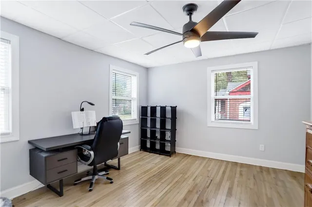 a view of a workspace with furniture and a window