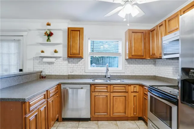 a kitchen with stainless steel appliances granite countertop a sink stove and cabinets