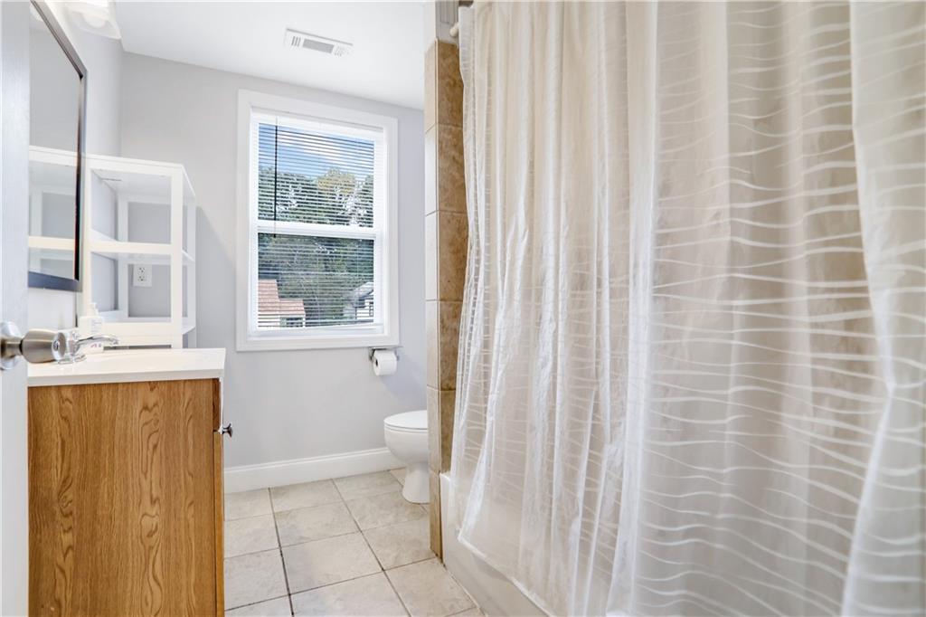 1275 Eastland Road Southeast Atlanta, GA 30316 - Photo 23 of 31 a bathroom with a granite countertop sink a toilet and a bathtub