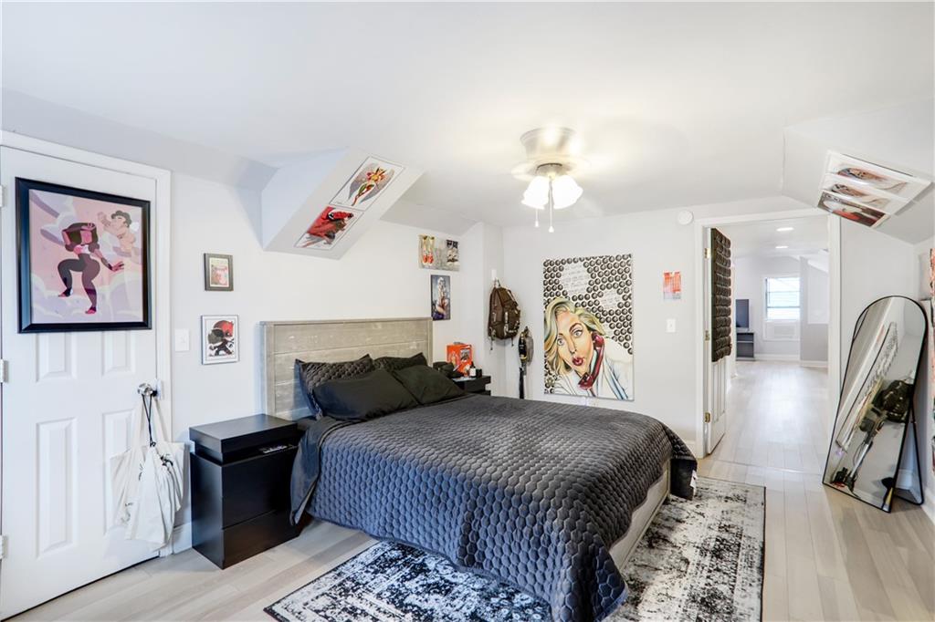 1275 Eastland Road Southeast Atlanta, GA 30316 - Photo 24 of 31 a bedroom with a bed and a chandelier