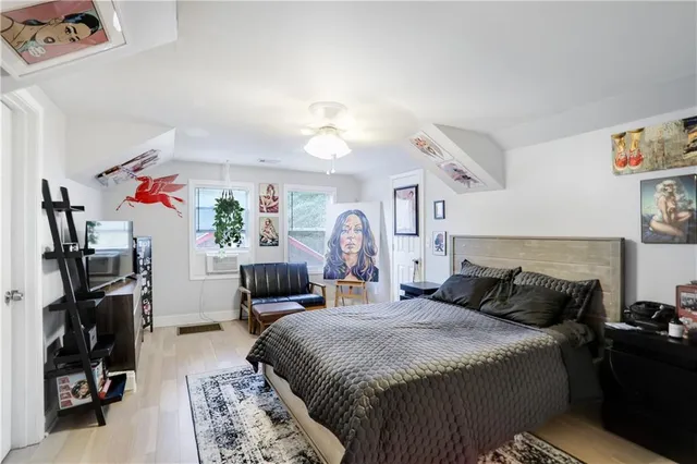 a bedroom with a bed and a tv