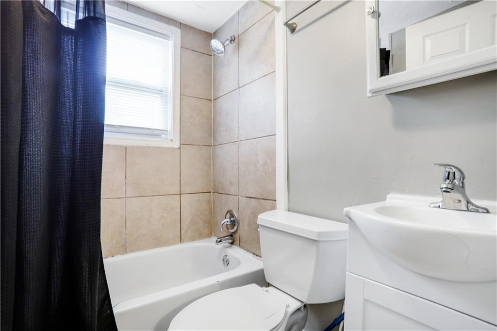 1275 Eastland Road Southeast Atlanta, GA 30316 - Photo 26 of 31 a white toilet sitting next to a bathroom sink