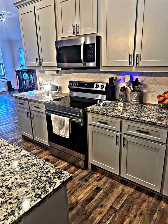 2631 Fish Tank Road Corsicana, TX 75110 - Photo 16 of 40 a kitchen with stainless steel appliances granite countertop a stove a sink and a microwave