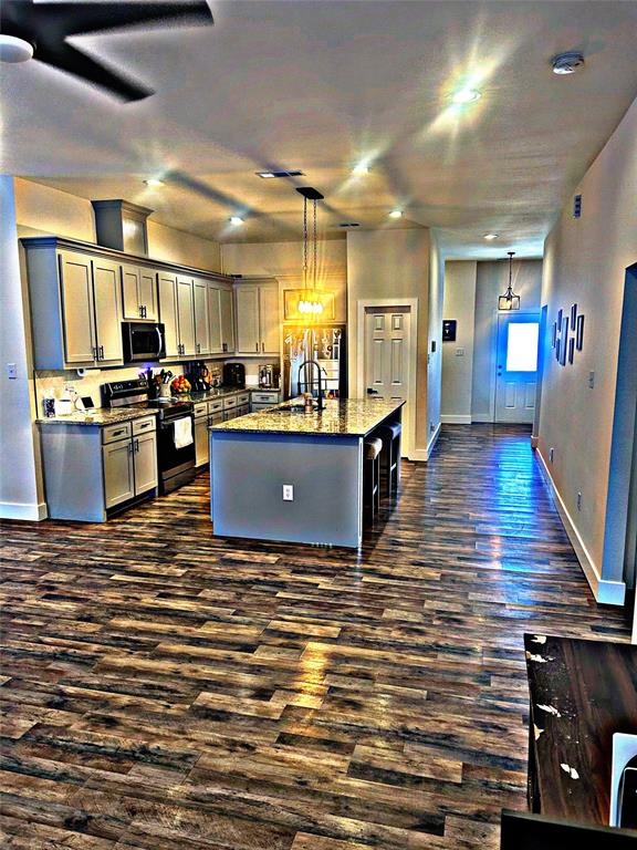 2631 Fish Tank Road Corsicana, TX 75110 - Photo 17 of 40 a kitchen with stainless steel appliances kitchen island granite countertop a stove and a refrigerator