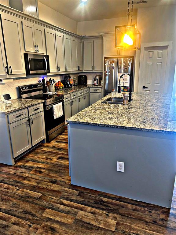 2631 Fish Tank Road Corsicana, TX 75110 - Photo 18 of 40 a kitchen with stainless steel appliances granite countertop a sink a stove counter space and cabinets