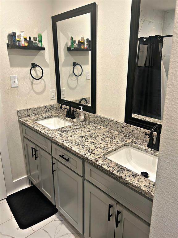 2631 Fish Tank Road Corsicana, TX 75110 - Photo 19 of 40 a bathroom with a granite countertop sink and a mirror