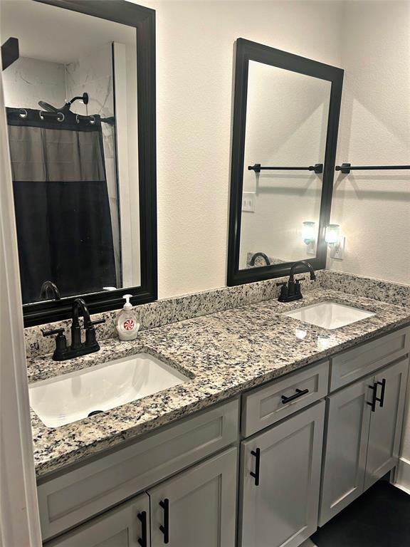 2631 Fish Tank Road Corsicana, TX 75110 - Photo 20 of 40 a bathroom with a granite countertop sink and a mirror