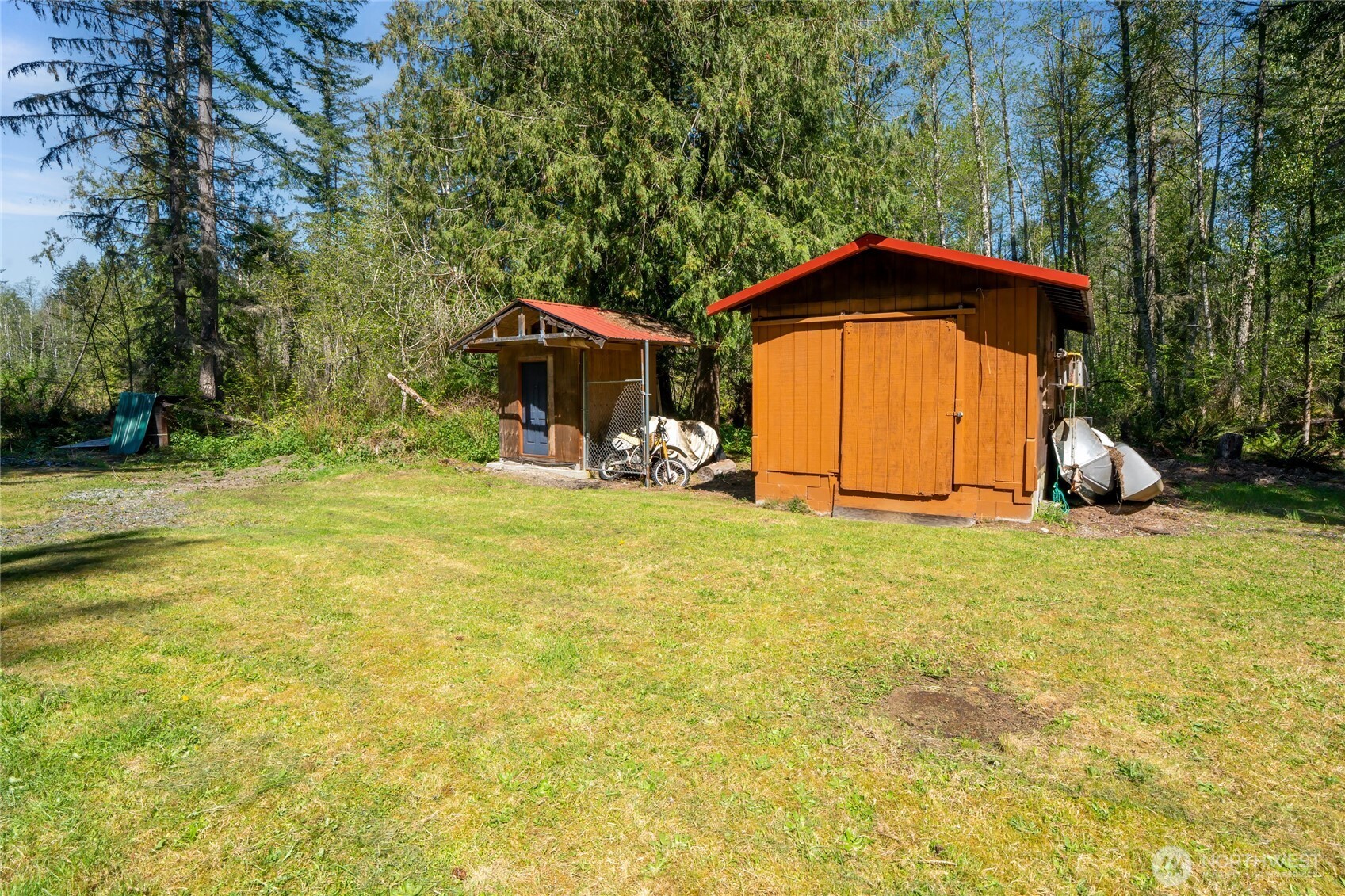 271 Skate Creek Road North Ashford, WA 98304 - Photo 35 of 40 a view of a backyard with table and chairs under an umbrella