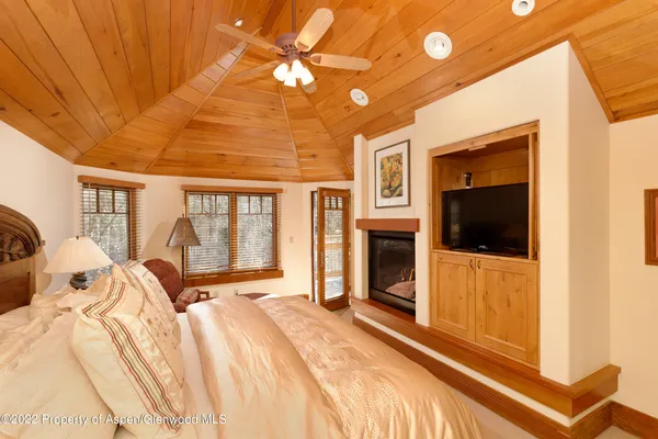 a bed room with a bed and a television