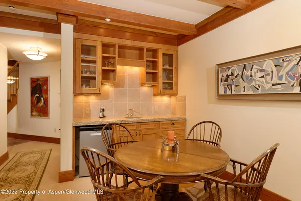 a dining room with furniture and wooden floor