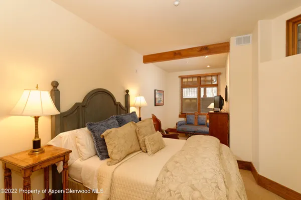 a bed room with a bed and a lamp
