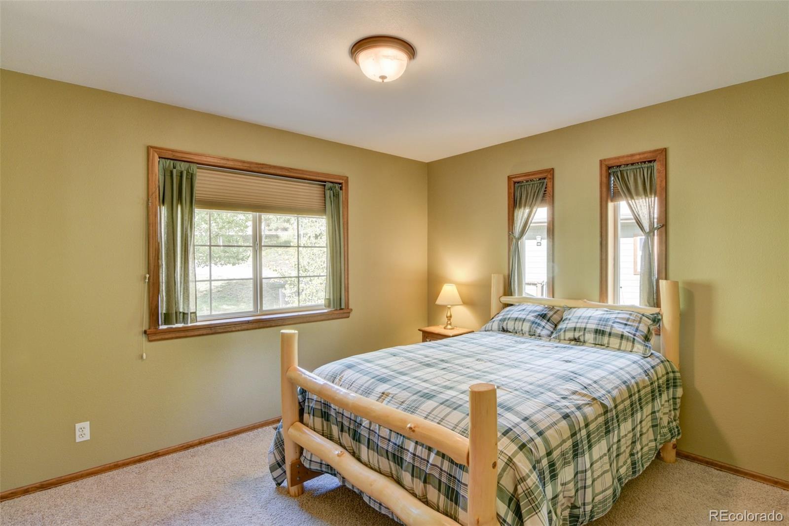821 Blacksmith Road Hartsel, CO 80449 - Photo 35 of 50 a bedroom with a bed and window