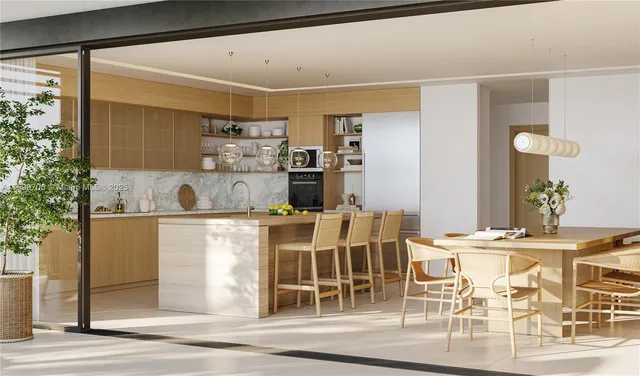 a kitchen with a dining table chairs and entryway