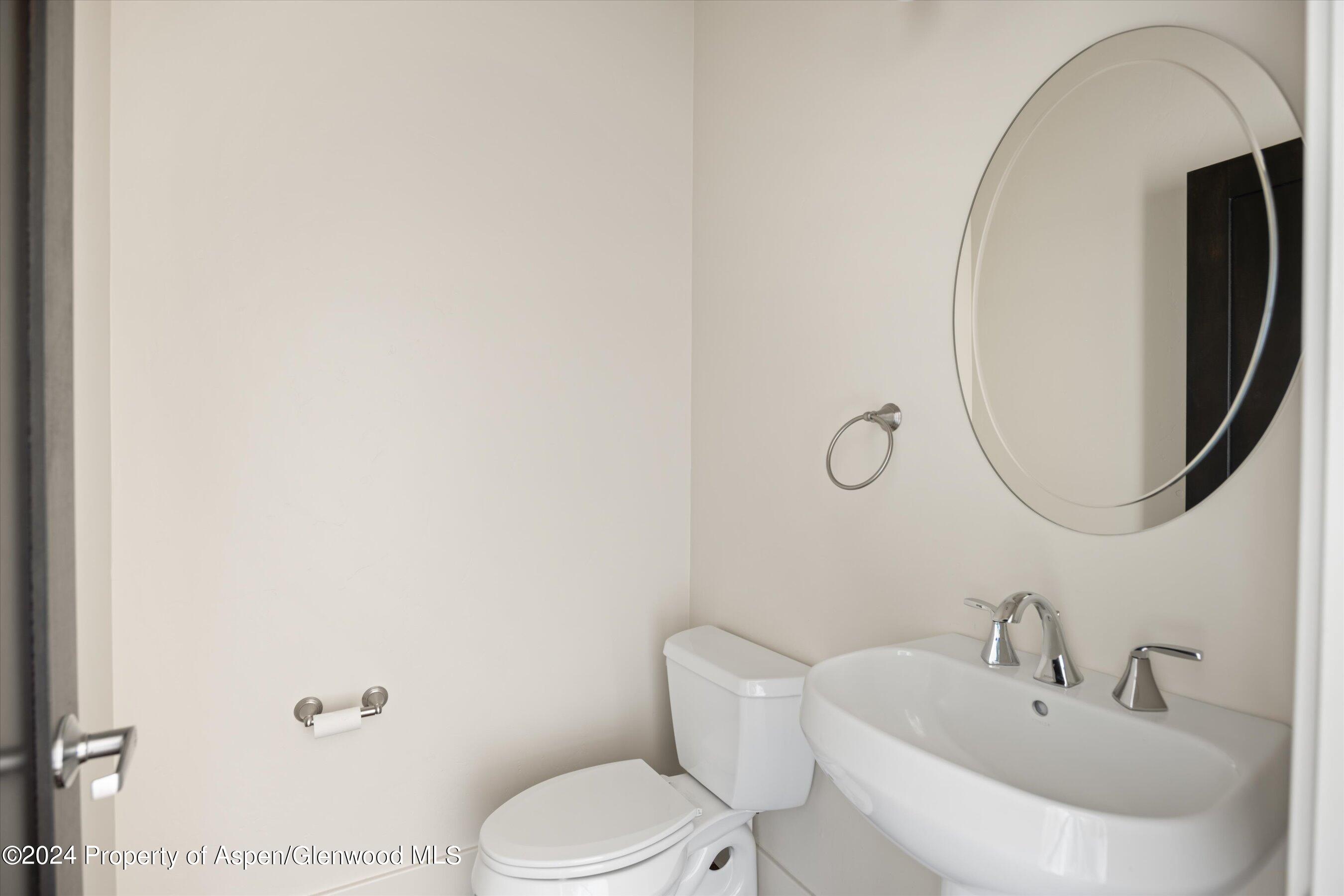 450 Jody Road Basalt, CO 81621 - Photo 17 of 22 a bathroom with a toilet a sink and mirror