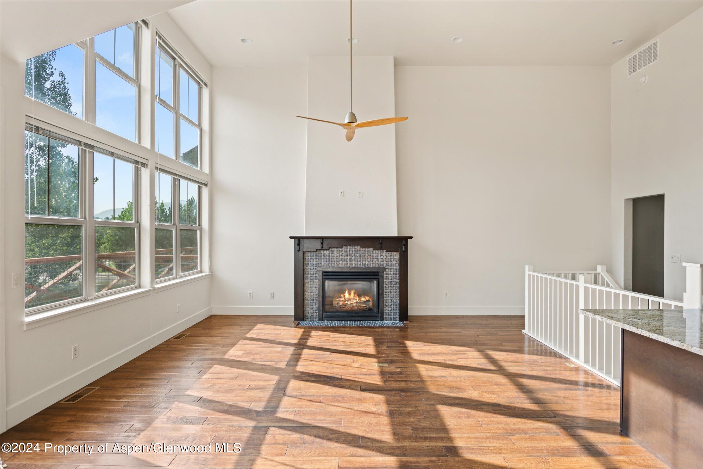 450 Jody Road Basalt, CO 81621 - Photo 6 of 22 a view of an empty room with a fireplace and a window