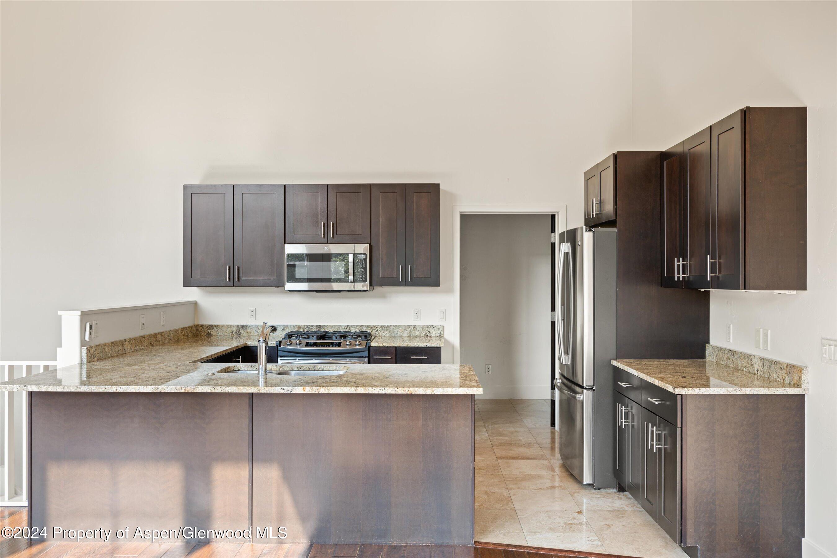 450 Jody Road Basalt, CO 81621 - Photo 7 of 22 a kitchen with stainless steel appliances granite countertop a refrigerator and a stove top oven