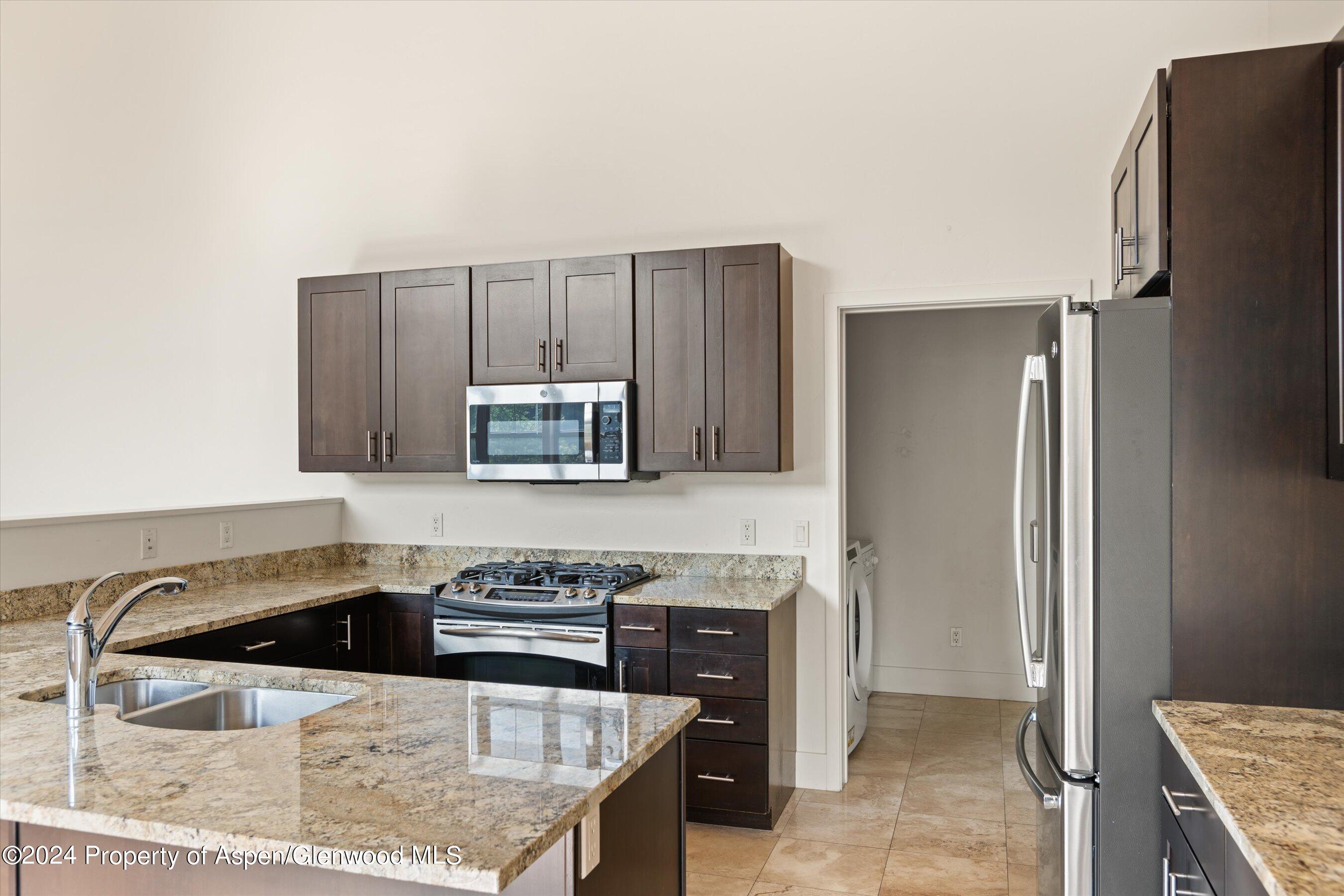 450 Jody Road Basalt, CO 81621 - Photo 10 of 22 a kitchen with granite countertop a refrigerator stove and sink
