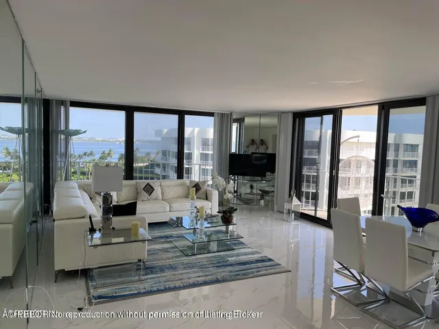 a living room with furniture large windows and a flat screen tv