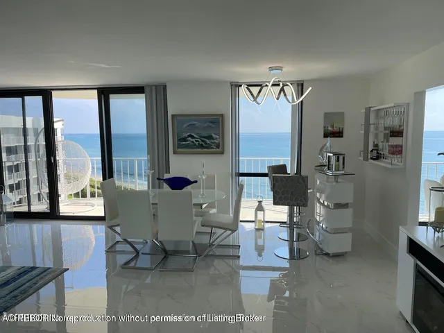 a living room with furniture and large windows