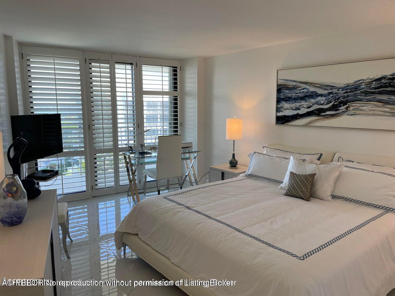 3360 South Ocean Boulevard, Unit 6CII Palm Beach, FL 33480 - Photo 8 of 12 a bedroom with a large bed and a flat tv screen on dresser