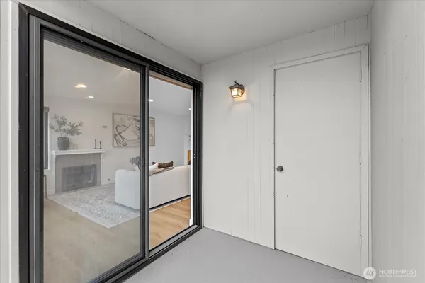 a bedroom with a bed a couch and a large window