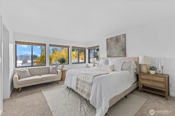 a bedroom with a large bed and a large window