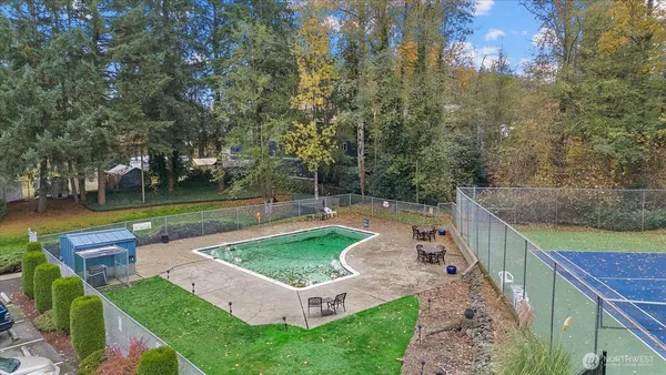 an aerial view of a house with a yard basket ball court