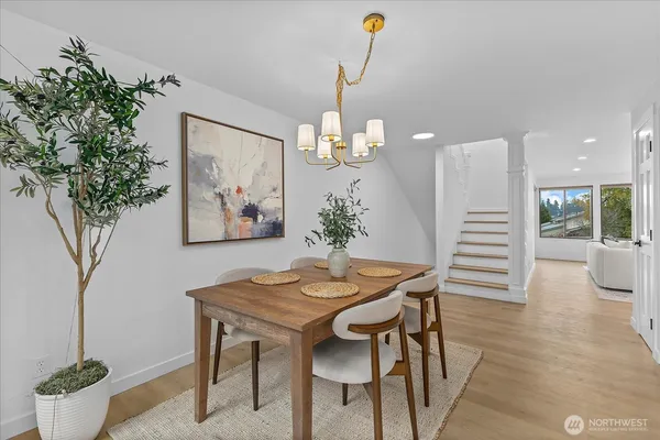 a dining room with furniture and wooden floor