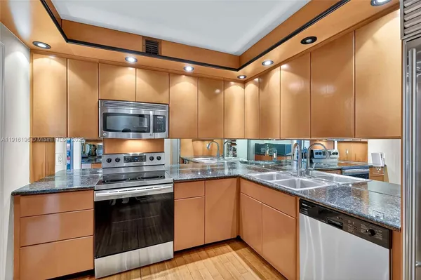 a kitchen with a sink and stainless steel appliances