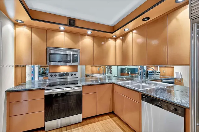 a kitchen with a sink and stainless steel appliances