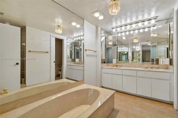 a large bathroom with a large mirror vanity and shower