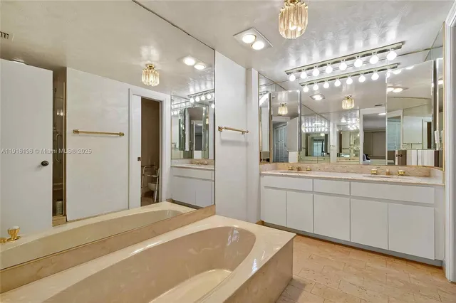 a large bathroom with a large mirror vanity and shower
